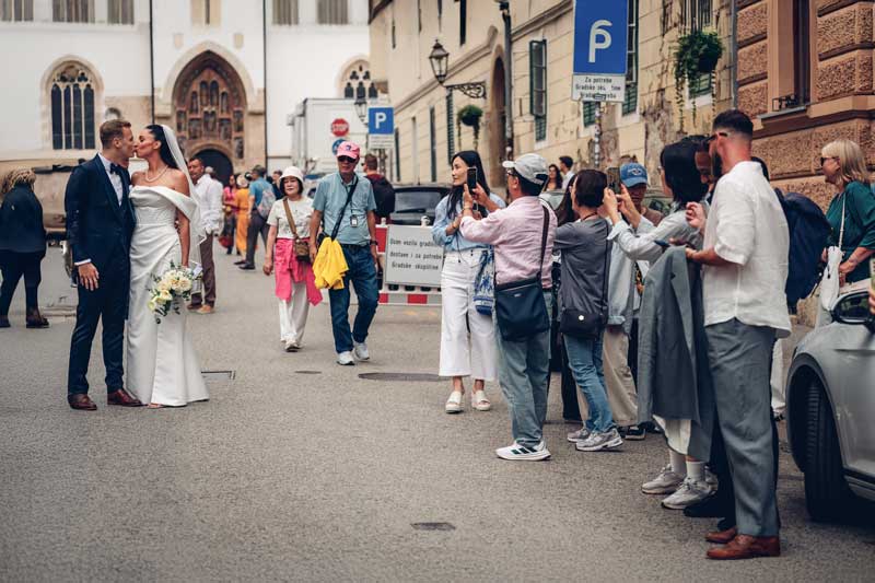 fotograf za vjenčanja - mladenci se ljube prolaznici ih gledaju - gornji grad